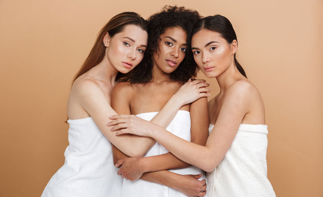 three-pretty-woman-wearing-towels-posing-together